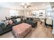 Open-concept living room featuring a comfortable sectional sofa, wood floors, and modern lighting at 3739 Silvery Way, Powder Springs, GA 30127