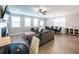 Spacious living room with a large sectional sofa, fireplace, dining table, and ample natural light at 3739 Silvery Way, Powder Springs, GA 30127