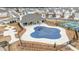 Community swimming pool with a covered blue safety tarp and nearby tennis courts at 3739 Silvery Way, Powder Springs, GA 30127