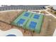 Overhead view of tennis courts within a fenced area, complemented by surrounding landscaping at 3739 Silvery Way, Powder Springs, GA 30127