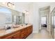 Luxurious bathroom featuring double sink vanity, granite countertops, and glass enclosed shower at 110 Canyon Ridge Trl, Canton, GA 30114
