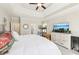 Spacious bedroom featuring a tray ceiling, carpet, a TV, and furnishings at 110 Canyon Ridge Trl, Canton, GA 30114