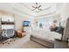 Well-lit Primary bedroom boasts tray ceiling, desk, and comfortable seating area at 110 Canyon Ridge Trl, Canton, GA 30114