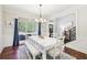 Cozy dining room with a large window, wainscoting, and hardwood floors at 110 Canyon Ridge Trl, Canton, GA 30114