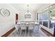 Elegant dining room with wainscoting, a chandelier, and large windows for natural light at 110 Canyon Ridge Trl, Canton, GA 30114
