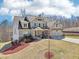 Charming two-story home featuring a blue exterior, a two-car garage and a well manicured lawn at 110 Canyon Ridge Trl, Canton, GA 30114