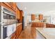 Open concept kitchen with stainless double ovens, breakfast bar, and hardwood floors at 110 Canyon Ridge Trl, Canton, GA 30114