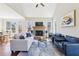 Comfortable living room featuring a brick fireplace and access to a deck with scenic views at 110 Canyon Ridge Trl, Canton, GA 30114