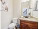Cozy powder room featuring stylish vanity, granite countertop, and wall decor at 110 Canyon Ridge Trl, Canton, GA 30114