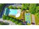 Aerial view showcasing community amenities including a pool, basketball court, playground, and lush landscaping at 172 Knightwood Point, Acworth, GA 30101