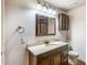 Well-lit bathroom features a dark wood vanity and neutral countertops for a classic look at 172 Knightwood Point, Acworth, GA 30101