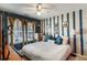 Nautical themed bedroom featuring blue striped walls, bright natural light, and a ceiling fan at 172 Knightwood Point, Acworth, GA 30101