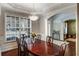 Elegant dining room with a wood table, decorative chandelier, and large windows offering ample natural light at 172 Knightwood Point, Acworth, GA 30101