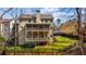 Back exterior view of a home with a multi-tiered deck, perfect for enjoying the surrounding natural setting at 172 Knightwood Point, Acworth, GA 30101