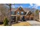 Two-story home with stone and wood accents, a covered front porch, and well-maintained landscaping at 172 Knightwood Point, Acworth, GA 30101