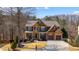 Beautiful two-story home with stone and wood accents, a covered front porch, and a well-manicured lawn at 172 Knightwood Point, Acworth, GA 30101