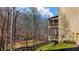 Exterior home view overlooking wooded landscape with a deck offering a serene outdoor living space at 172 Knightwood Point, Acworth, GA 30101