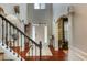 Foyer view showcases hardwood floors, arched entryway, white trim, staircase, and front door at 172 Knightwood Point, Acworth, GA 30101