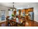 Spacious kitchen features stainless steel appliances, wooden cabinets, and an adjacent dining area bathed in natural light at 172 Knightwood Point, Acworth, GA 30101