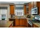 Modern kitchen with stainless steel appliances, granite counters, wooden cabinets, and a window with natural light at 172 Knightwood Point, Acworth, GA 30101