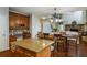 Open-concept kitchen and dining area with a center island, wood table, and views of an open living space at 172 Knightwood Point, Acworth, GA 30101