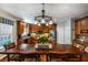 Well-lit kitchen features wood cabinets, stainless steel appliances, and a large center island with a dining table at 172 Knightwood Point, Acworth, GA 30101