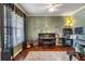 A well-lit music room with a piano, keyboard, and musical instruments is staged for a comfortable and artistic atmosphere at 172 Knightwood Point, Acworth, GA 30101