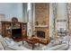 Bright living room features stone fireplace, large built-in cabinet, and a plush seating area at 172 Knightwood Point, Acworth, GA 30101