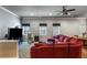 Spacious living room features plush red sectional sofa, neutral walls, and carpeted flooring at 172 Knightwood Point, Acworth, GA 30101