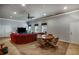 Bright living room featuring plush sofa, table with chairs, carpet, and multiple entry points at 172 Knightwood Point, Acworth, GA 30101