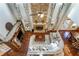 Open concept living room boasts hardwood floors, stone fireplace, and large windows at 172 Knightwood Point, Acworth, GA 30101