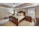Tranquil main bedroom featuring a ceiling fan, tray ceiling and neutral color palette for a relaxing ambiance at 172 Knightwood Point, Acworth, GA 30101