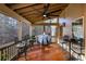 Inviting screened porch with wood floors, ceiling fan, and outdoor seating for enjoying nature views at 172 Knightwood Point, Acworth, GA 30101