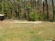 View of the backyard, showing the lawn, fence, and some wooded cover at 3701 Rainbow Cir, Snellville, GA 30039