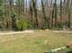 Large, fenced backyard, and wooded area with mature trees for privacy at 3701 Rainbow Cir, Snellville, GA 30039