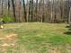A spacious grassy backyard, perfect for outdoor activities and relaxation, with a riding lawnmower visible at 3701 Rainbow Cir, Snellville, GA 30039
