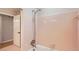 Bathroom with pink tile, shower, and tub at 3701 Rainbow Cir, Snellville, GA 30039