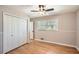 Bedroom features wood floors, a ceiling fan, and closet at 3701 Rainbow Cir, Snellville, GA 30039