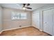 Bedroom features a ceiling fan, hardwood floors, window and closet with paneled doors at 3701 Rainbow Cir, Snellville, GA 30039