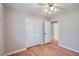 Bedroom with hardwood floors, a ceiling fan, and closet with folding doors at 3701 Rainbow Cir, Snellville, GA 30039