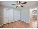 Bedroom with ceiling fan, hardwood floors, window, closet, and neutral paint at 3701 Rainbow Cir, Snellville, GA 30039