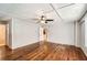 Spacious bedroom features wood paneling, hardwood floors, and a ceiling fan at 3701 Rainbow Cir, Snellville, GA 30039