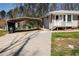 Side view of house featuring a convenient carport, paved driveway, and tidy landscaping at 3701 Rainbow Cir, Snellville, GA 30039