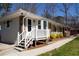 Charming covered porch with white railing and brick details, perfect for relaxing outdoors at 3701 Rainbow Cir, Snellville, GA 30039