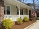 Close-up of front porch showcasing the white railing, brick accents, and tidy landscaping at 3701 Rainbow Cir, Snellville, GA 30039