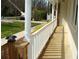 Covered front porch detail with white pillars, decorative railing, and manicured shrubs at 3701 Rainbow Cir, Snellville, GA 30039