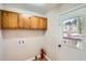 Laundry room with cabinets, door to backyard, and tile floor at 3701 Rainbow Cir, Snellville, GA 30039