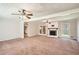 Spacious living room with a fireplace, large windows, and neutral carpeting at 3701 Rainbow Cir, Snellville, GA 30039