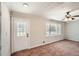 Cozy living room with natural light, neutral carpeting, and a classic ceiling fan at 3701 Rainbow Cir, Snellville, GA 30039
