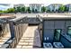 Aerial view of modern townhomes with rooftop patios overlooking a city skyline at 1239 Chelsea Nw Cir, Atlanta, GA 30318